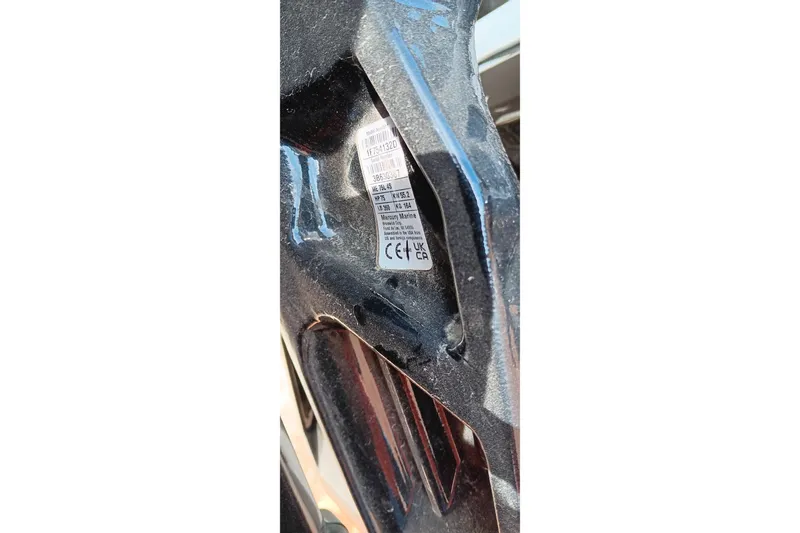 Slide: The Image of Close-up of a 2024 Tracker Pro Team 175 TXW boat label on a dark surface. - 23