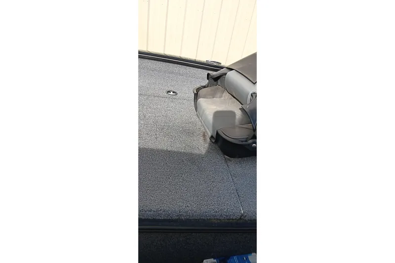 Slide: The Image of 2024 Tracker Pro Team 175 TXW boat interior with gray seating and carpeted deck. - 4