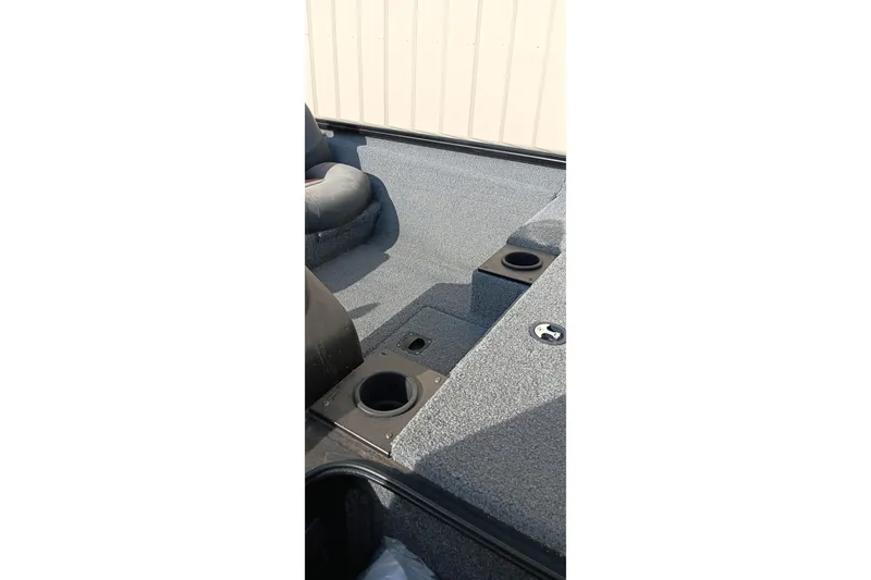 Slide: The Image of 2024 Tracker Pro Team 175 TXW boat interior with cup holders and seating area. - 5