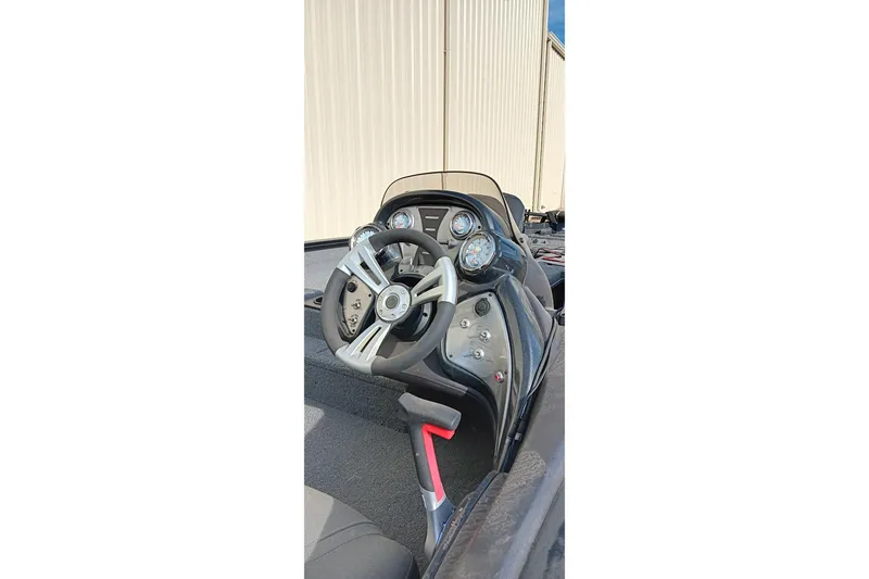 Slide: The Image of 2024 Tracker Pro Team 175 TXW boat dashboard with steering wheel and gauges. - 8