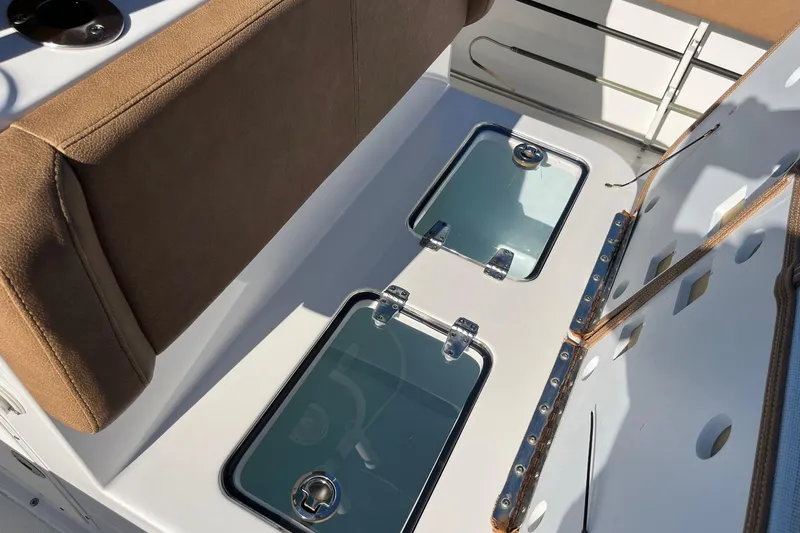 Slide: The Image of 2021 Sea Hunt Gamefish 27 Coffin Box interior with cushioned seating and storage compartments. - 10