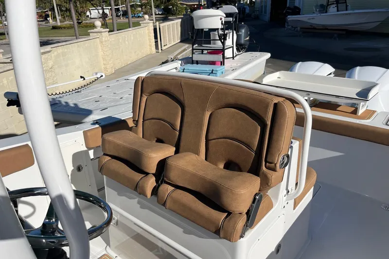 Slide: The Image of 2021 Sea Hunt Gamefish 27 Coffin Box boat with brown cushioned seating. - 5