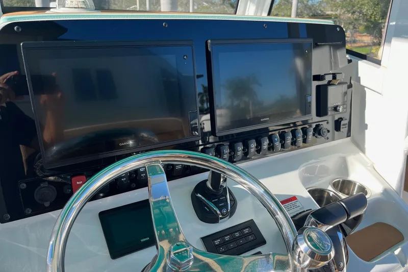 Slide: The Image of 2021 Sea Hunt Gamefish 27 Coffin Box helm with dual Garmin displays and steering wheel. - 7