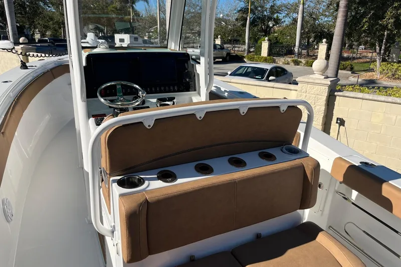 Slide: The Image of 2021 Sea Hunt Gamefish 27 Coffin Box boat interior with helm and seating. - 9