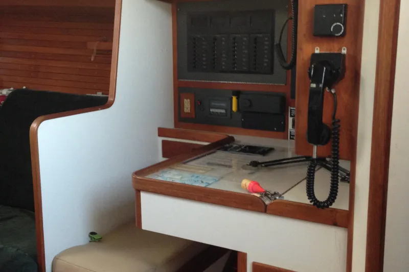 Slide: The Image of Navigation station inside a 1989 J Boats J/44 sailboat, featuring communication equipment and control panel. - 15
