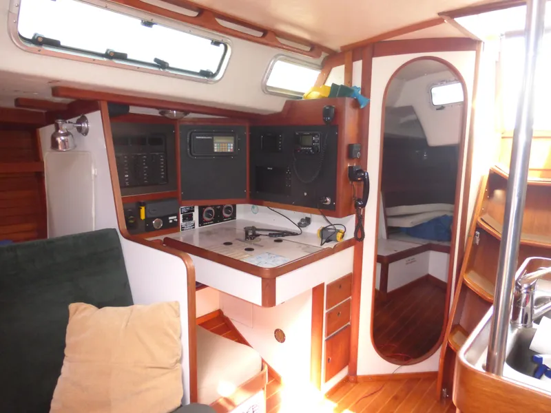 Slide: The Image of Interior of 1989 J Boats J/44 sailboat with navigation station and cozy cabin. - 16