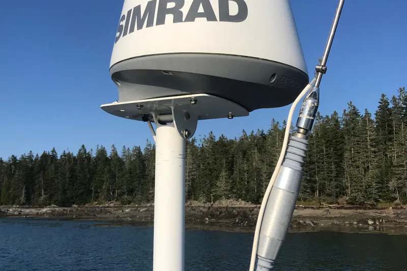 Slide: The Image of Simrad radar on 1989 J Boats J/44 sailboat, with forested shoreline in background. - 18