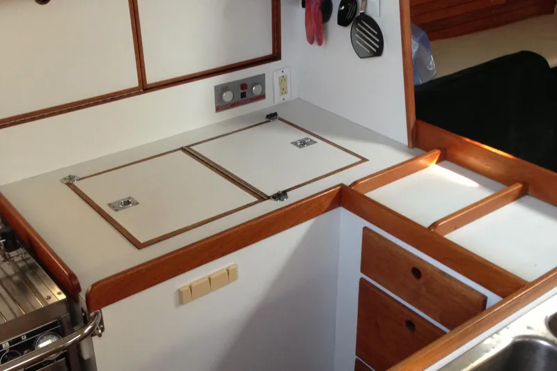 Slide: The Image of Galley of 1989 J Boats J/44 sailboat with wooden trim and storage compartments. - 20