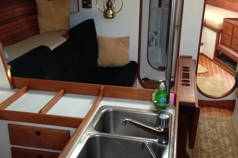 Slide: The Image of Interior of 1989 J Boats J/44 sailboat with kitchen sink and cozy seating area. - 21