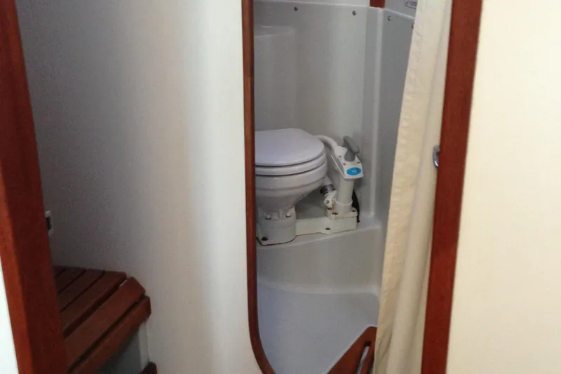 Slide: The Image of 1989 J Boats J/44 yacht bathroom with toilet and wooden seat. - 25