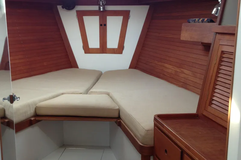 Slide: The Image of Interior cabin of 1989 J Boats J/44 with wooden finish and beige cushions. - 27