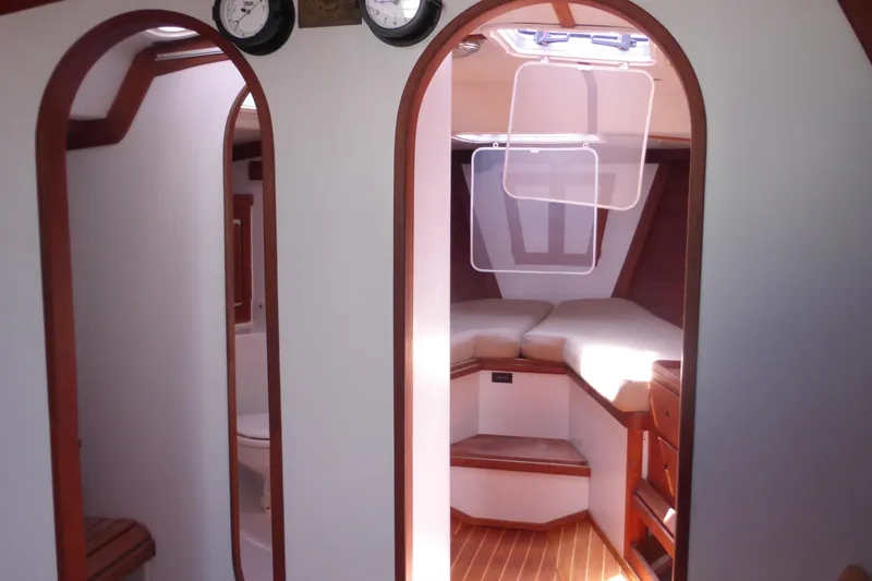 Slide: The Image of Interior of 1989 J Boats J/44 sailboat, featuring cozy cabin with wood accents. - 29