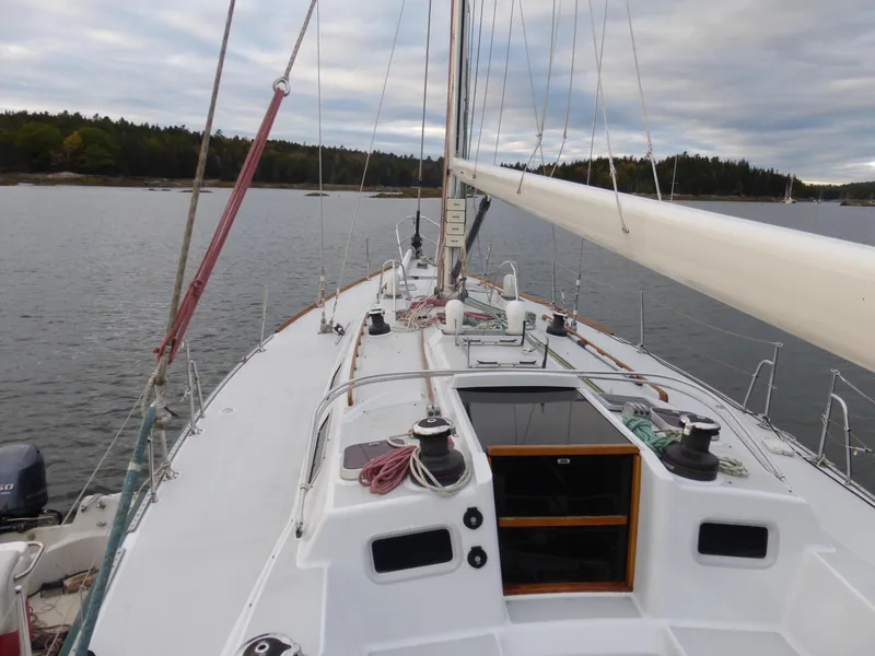 Slide: The Image of 1989 J Boats J/44 sailboat on calm water, showcasing deck and rigging. - 3