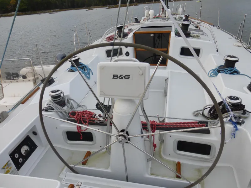 Slide: The Image of 1989 J Boats J/44 sailboat cockpit with steering wheel and B&G navigation system. - 6