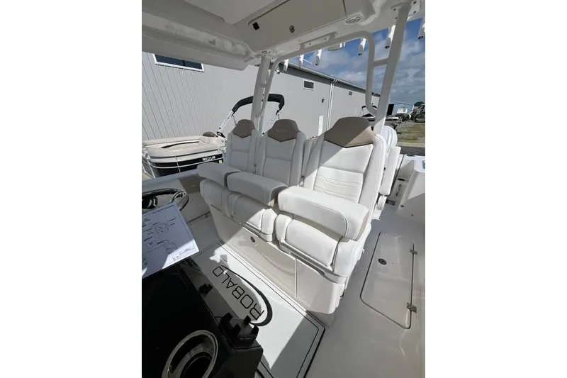 Slide: The Image of 2026 Robalo R300 Center Console boat with luxurious white seating and modern design. - 14