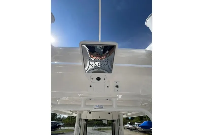 Slide: The Image of 2026 Robalo R300 Center Console boat roof with mounted equipment under clear sky. - 16