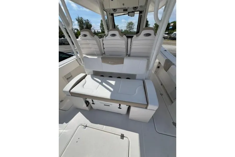 Slide: The Image of 2026 Robalo R300 Center Console boat interior with white seating and storage compartments. - 17