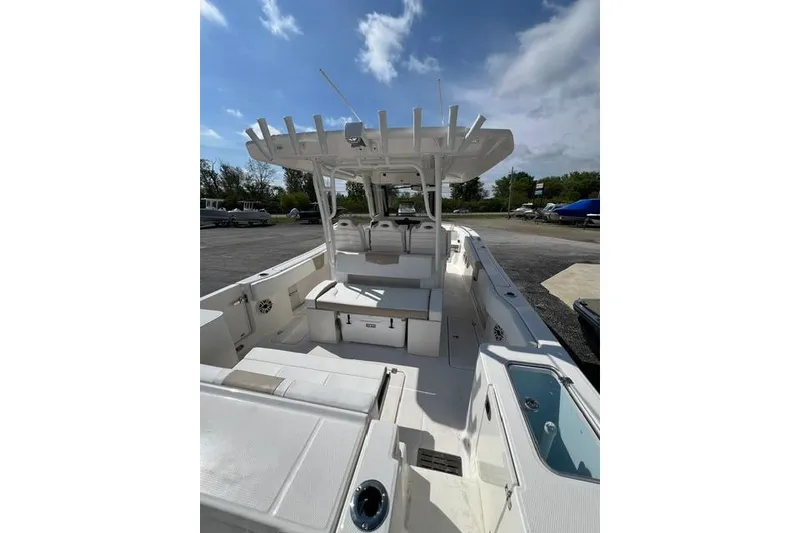 Slide: The Image of 2026 Robalo R300 Center Console boat with spacious deck and seating under clear sky. - 19
