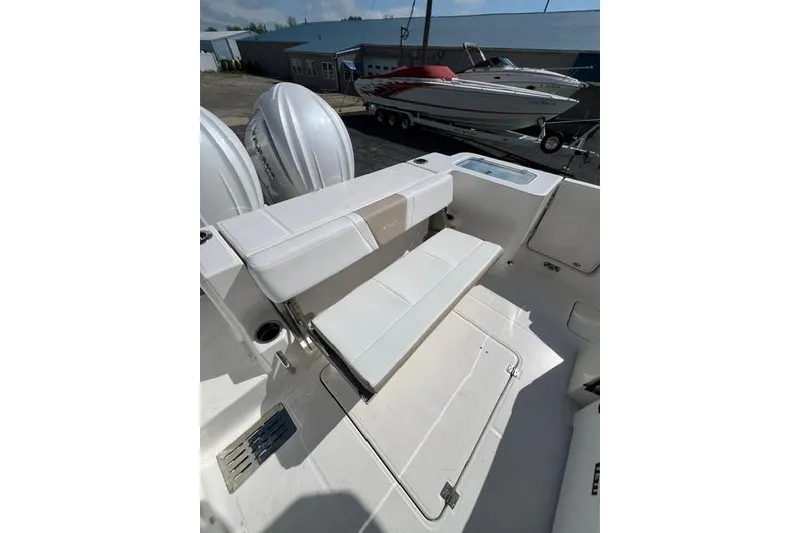 Slide: The Image of 2026 Robalo R300 Center Console boat interior with seating and dual outboard engines. - 21