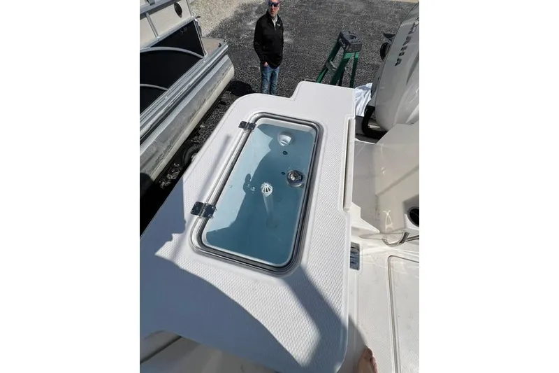 Slide: The Image of 2026 Robalo R300 Center Console boat deck with livewell and engine view. - 23
