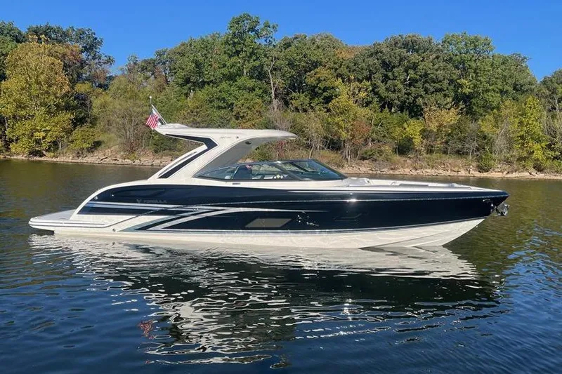 The Image of 2026 Formula 360 Crossover Bowrider I/O on a serene lake with forested background. - 0