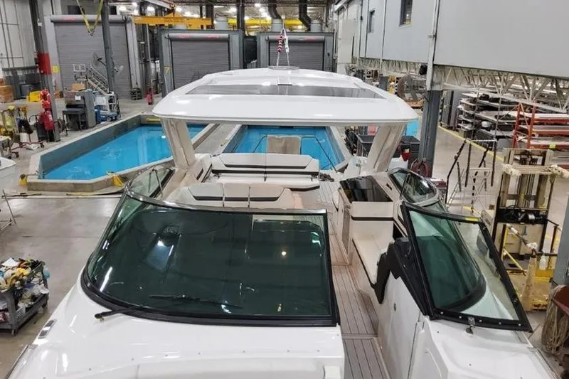 Slide: The Image of 2026 Formula 360 Crossover Bowrider I/O in a manufacturing facility, showcasing sleek design. - 11