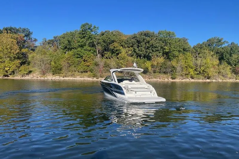 Slide: The Image of 2026 Formula 360 Crossover Bowrider I/O on a serene lake with lush green trees. - 19