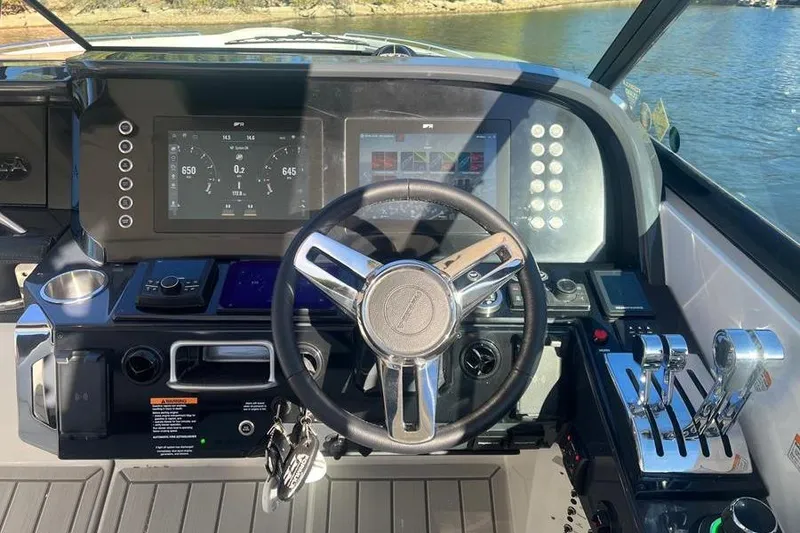 Slide: The Image of 2026 Formula 360 Crossover Bowrider I/O dashboard with modern controls and steering wheel. - 21
