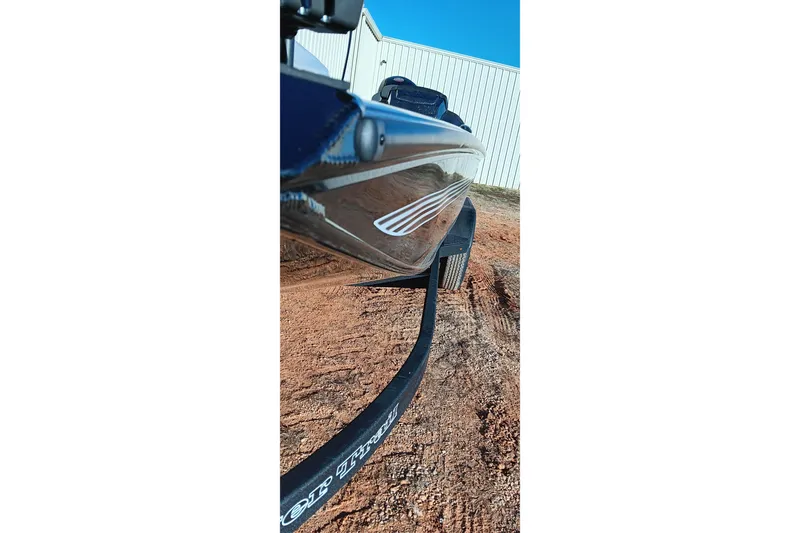 Slide: The Image of 2026 Ranger RT198P boat on trailer, parked on dirt near a white building. - 12