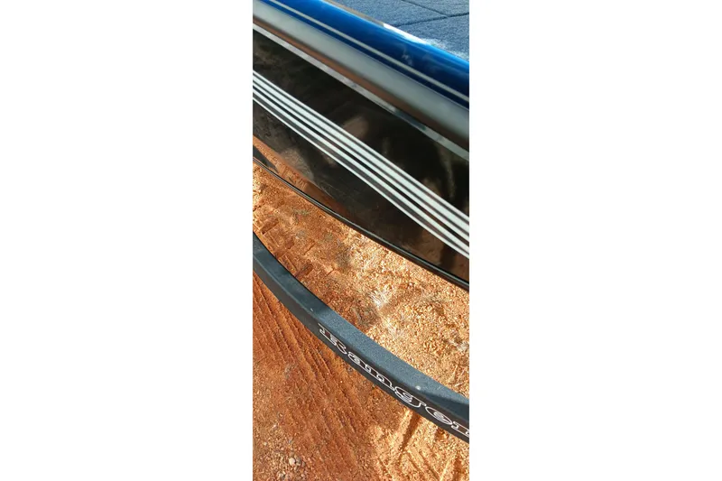 Slide: The Image of 2026 Ranger RT198P boat detail on sandy terrain, showcasing sleek design and branding. - 17