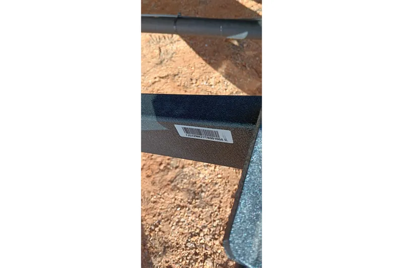 Slide: The Image of Barcode on 2026 Ranger RT198P boat component, placed on sandy ground. - 23