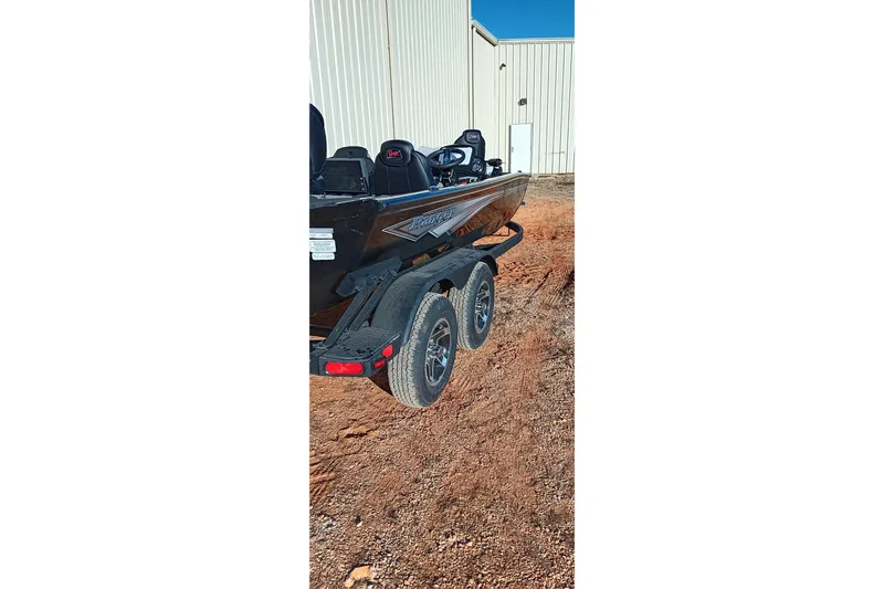 Slide: The Image of 2026 Ranger RT198P boat on trailer, parked on dirt near a building. - 3