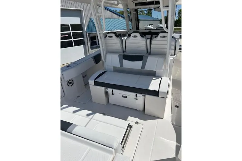 Slide: The Image of 2026 Robalo R300 Center Console boat interior with white seating and storage compartments. - 13