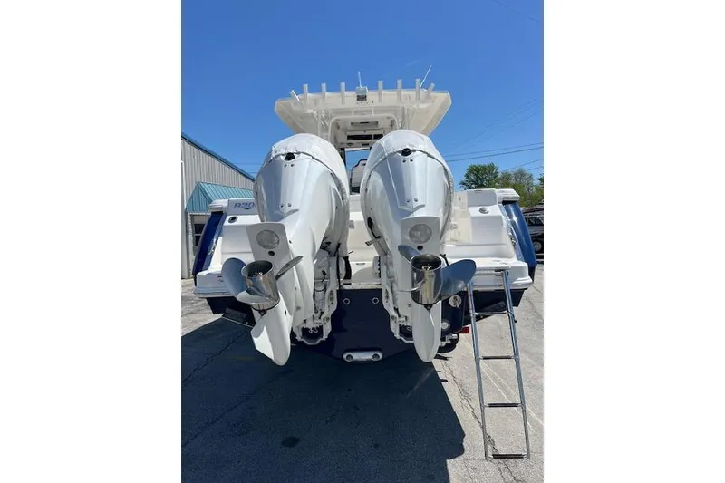 Slide: The Image of 2026 Robalo R300 Center Console boat with dual outboard engines, rear view. - 20