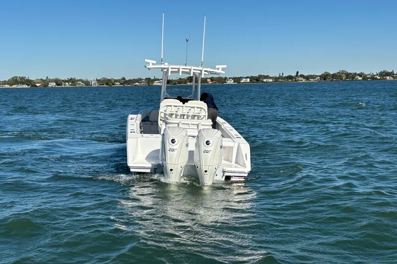 Slide: The Image of 2026 Jupiter 26 boat with dual engines cruising on a sunny day. - 10