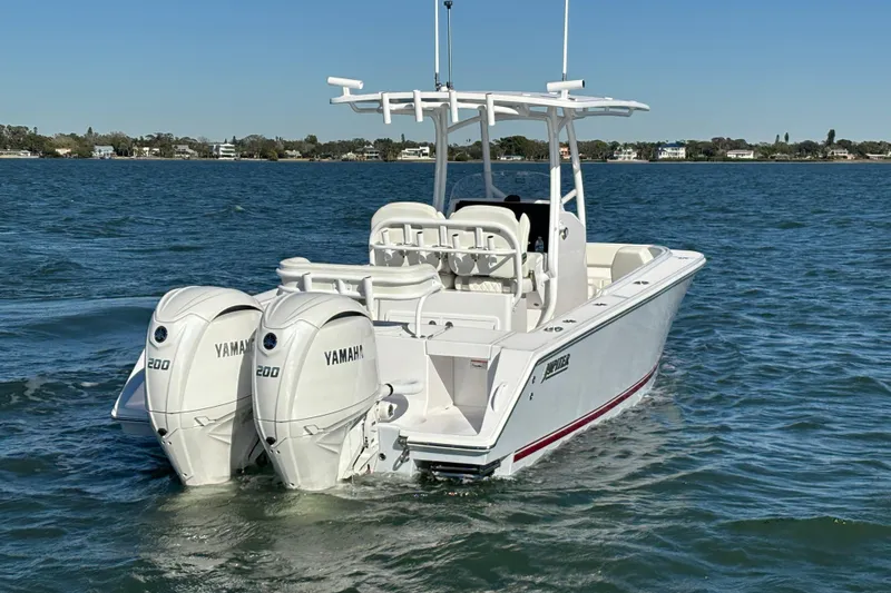Slide: The Image of 2026 Jupiter 26 boat with twin Yamaha 200 engines on open water. - 11