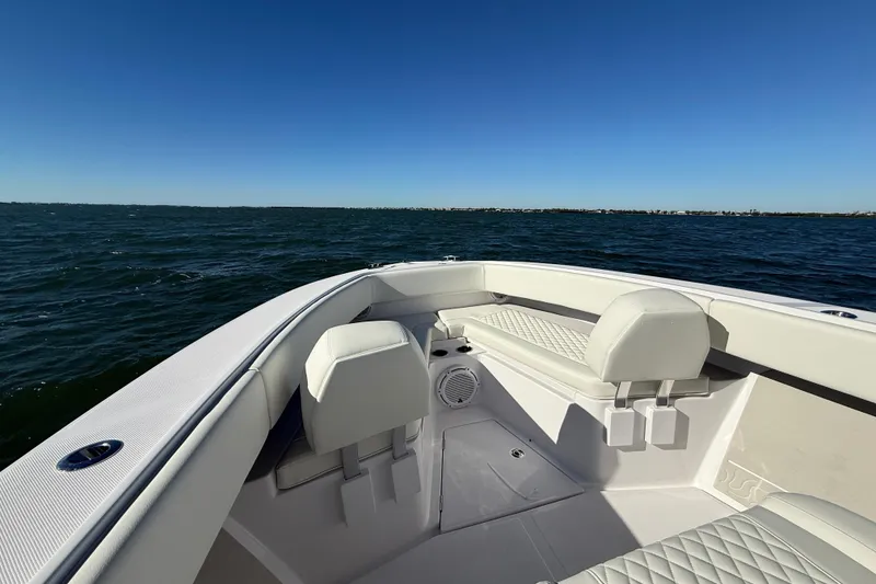 Slide: The Image of Front view of 2026 Jupiter 26 boat on open water under clear blue sky. - 12