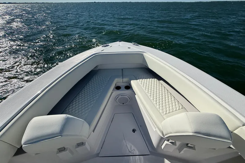 Slide: The Image of Bow seating area of 2026 Jupiter 26 boat on open water. - 13