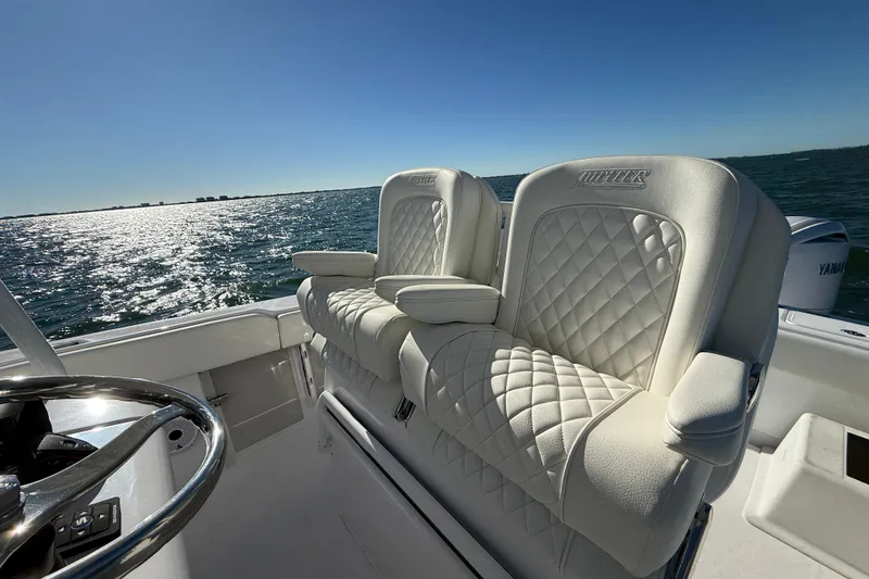 Slide: The Image of Luxurious seating on 2026 Jupiter 26 boat with ocean view and Yamaha engine. - 16