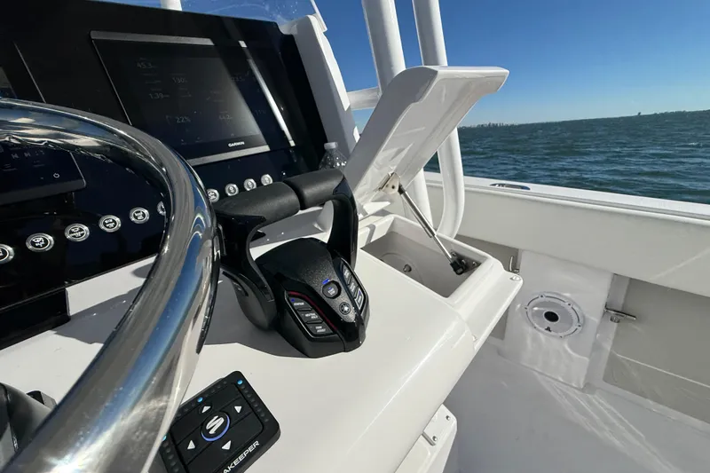 Slide: The Image of Helm of 2026 Jupiter 26 boat with modern controls and ocean view. - 18