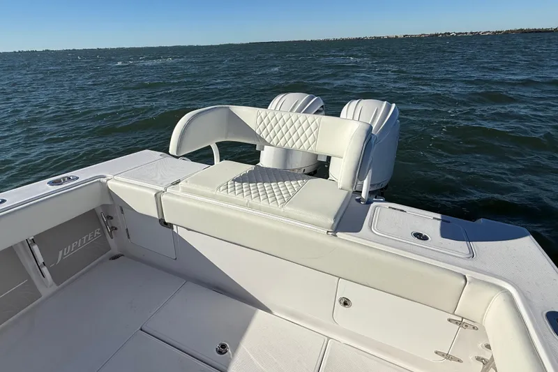 Slide: The Image of Luxury seating on 2026 Jupiter 26 boat with ocean backdrop. - 19