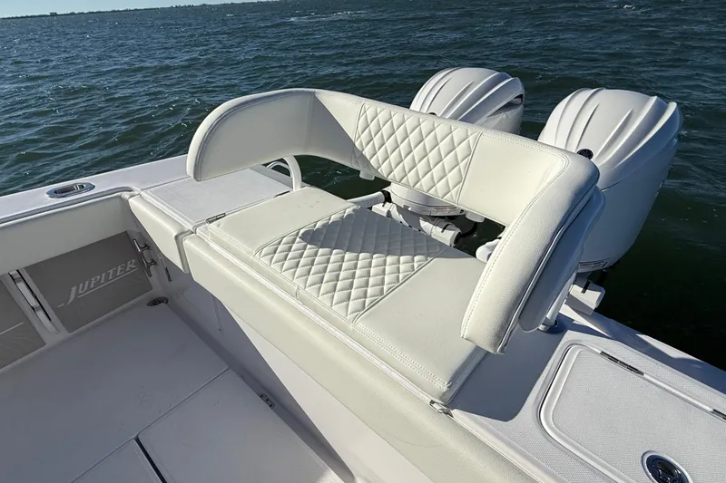 Slide: The Image of Luxury seating on 2026 Jupiter 26 boat with dual engines, on open water. - 20