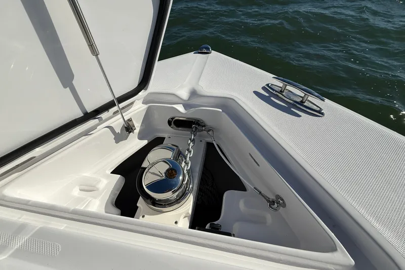Slide: The Image of Anchor compartment of 2026 Jupiter 26 boat with chrome fittings and ocean backdrop. - 25