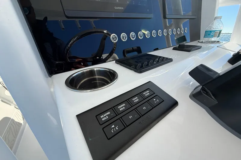 Slide: The Image of Control panel of 2026 Jupiter 26 boat with navigation and cup holder. - 29