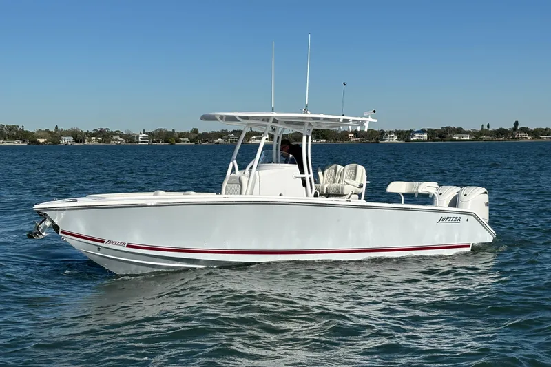 Slide: The Image of 2026 Jupiter 26 boat cruising on a calm blue lake under clear skies. - 8