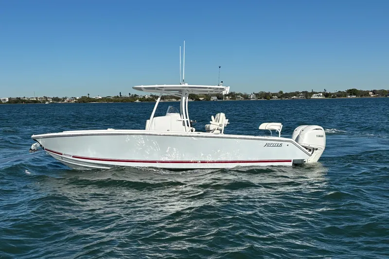 Slide: The Image of 2026 Jupiter 26 boat cruising on a calm blue sea under a clear sky. - 9