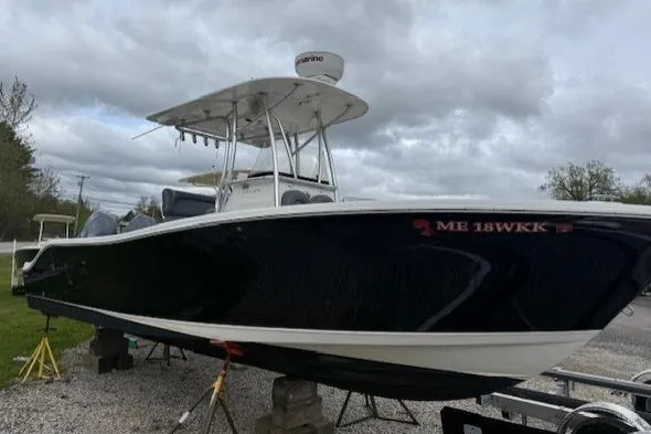 Slide: The Image of 2013 NauticStar 2500XS Offshore boat on stands under cloudy sky. - 2