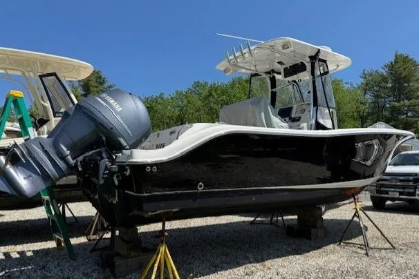 Slide: The Image of 2013 NauticStar 2500XS Offshore boat on stands, featuring Yamaha outboard motor. - 3
