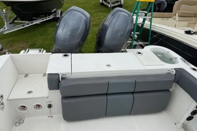 Slide: The Image of 2013 NauticStar 2500XS Offshore boat with dual outboard motors and cushioned seating. - 9