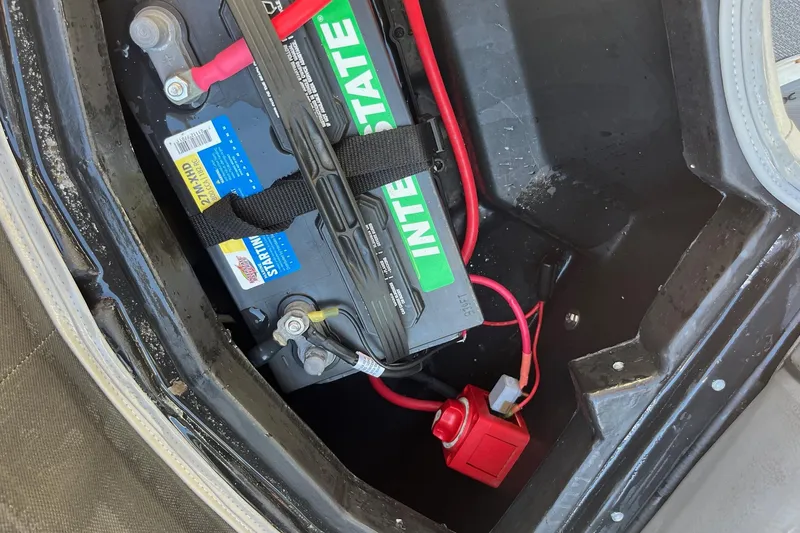 Slide: The Image of Battery compartment of 2023 Veranda Relax VR22RC with Interstate battery and red wiring. - 6